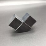 Custom machined black plastic 90-degree corner guide block