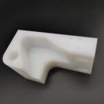 Machined UHMWPE complex curved fixture mounting block