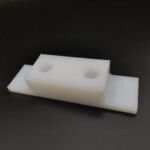 Custom CNC machined UHMWPE mounting block with hex nut housing