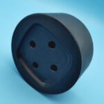 Thick black plastic custom CNC machined mounting block with recessed bolt hole pattern
