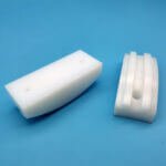 White plastic curved grooved sliding wear block for conveyor chain guiding