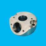 Custom CNC machined metal manifold block with angled ports for pneumatic systems